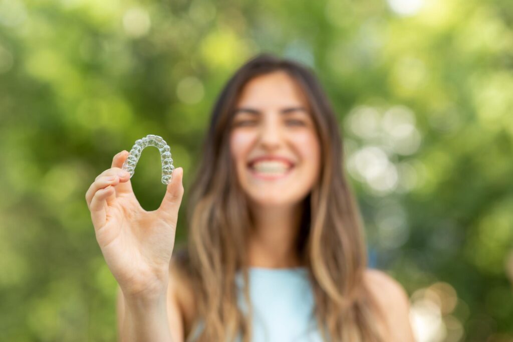 Person holding a clear aligner tray