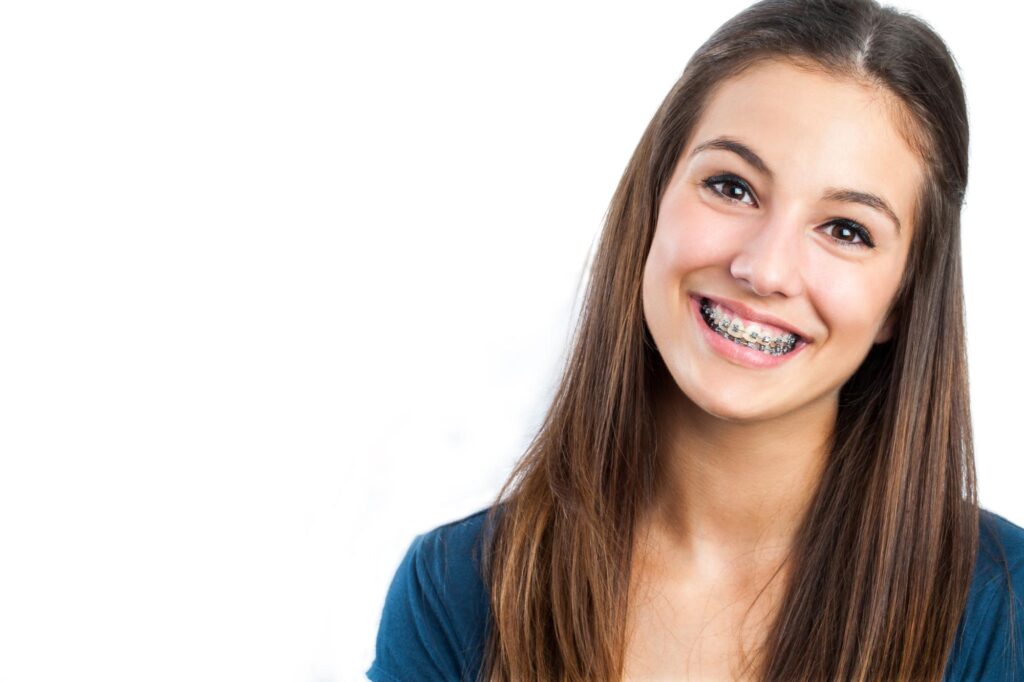 Girl smiling with braces on her teeth