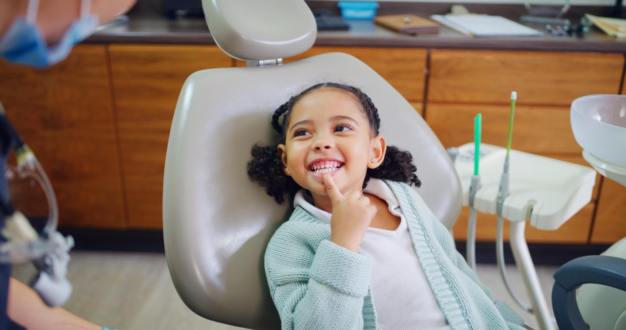 Young orthodontic patient smiling in the dental chair