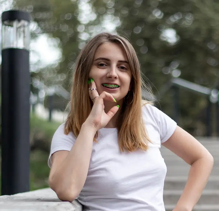 Teen smiling outdoors in the sunlight