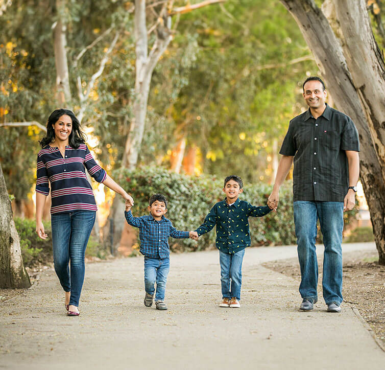 Family of four walking together outdoors